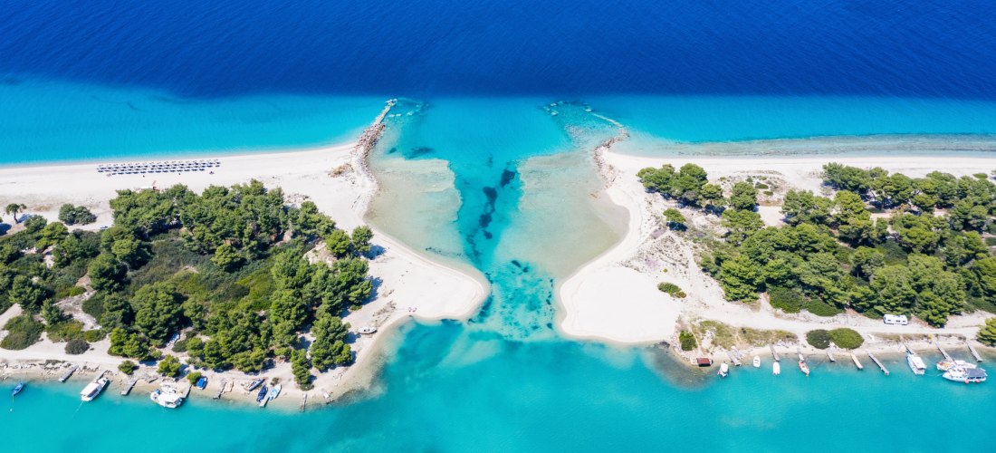 Atemberaubende Luftaufnahme des Kanals von Potidea auf Chalkidiki, wo zwei Strände und türkisfarbenes Wasser aufeinandertreffen. Ideal für Strandurlaub in Griechenland.