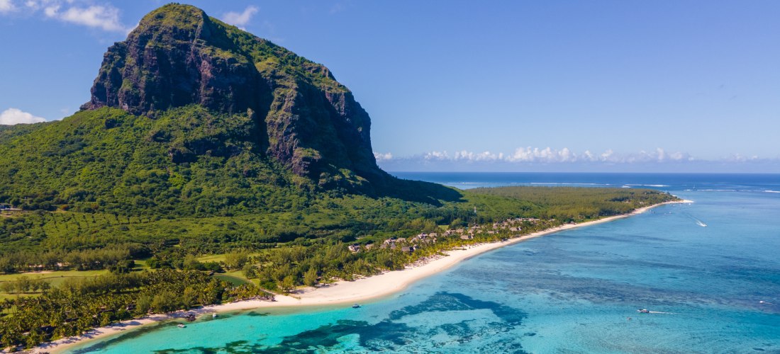 Der Le Morne Brabant Berg auf Mauritius mit weißem Sandstrand und türkisfarbenem Meer aus der Luft gesehen