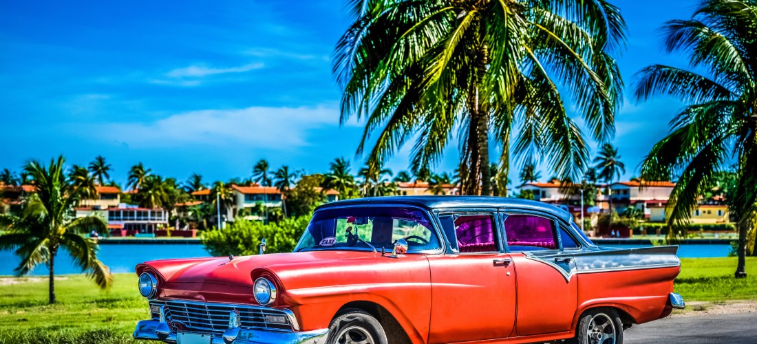 Kuba Oldtimer – klassisches amerikanisches Auto vor Palmenkulisse in Varadero Roter amerikanischer Oldtimer aus den 1950er-Jahren vor Palmen und Lagune in Varadero auf Kuba – ikonisches Symbol der kubanischen Kultur und Lebensfreude.