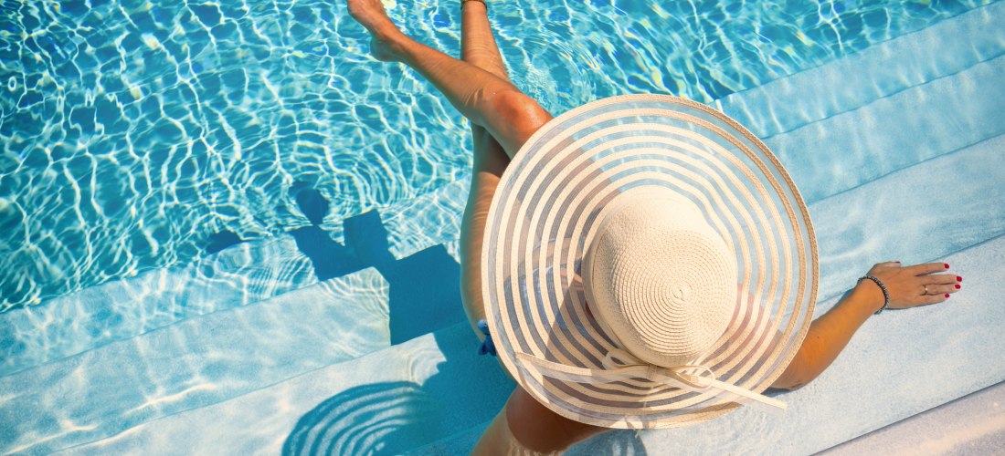 Frau mit Hut im Pool
