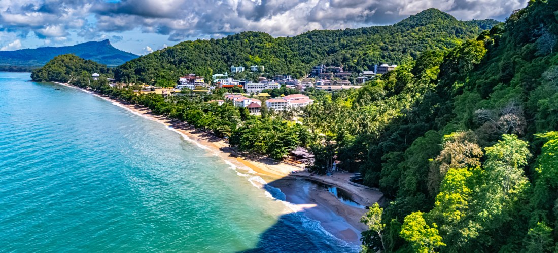 Ao Nang Küste in Krabi, Thailand: goldene Sandstrände, türkisfarbenes Meer und üppig bewaldete Hügel.