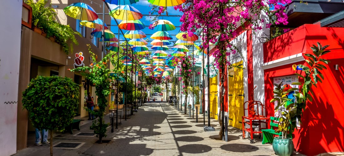 Bunte Regenschirme über einer Fußgängerzone in Puerto Plata, Dominikanische Republik