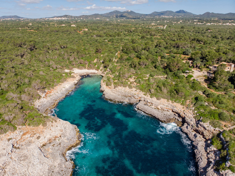 Luftaufnahme der Cala Brafi bei Felanitx auf Mallorca mit felsiger Bucht und türkisblauem Wasser