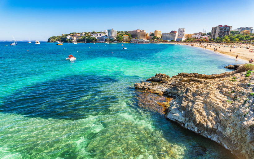 Playa de Palmanova – Sandstrand und türkisfarbene Bucht im Südwesten Mallorcas Blick auf die Playa de Palmanova in Calvia mit feinsandigem Strand, klarem türkisfarbenem Wasser und Hotels entlang der geschwungenen Bucht.