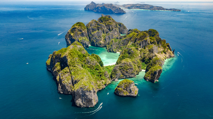 Phi Phi Islands bei Phuket – Tropisches Paradies aus der Luft Atemberaubende Luftaufnahme der Phi Phi Islands bei Phuket, Thailand, mit grünen Kalksteinfelsen, weißen Stränden und türkisfarbenem Meer.