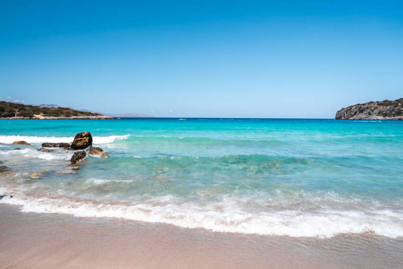Ruhiger Strand auf Kreta mit türkisfarbenem Meer und sanften Wellen
