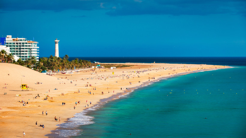 Küstenpanorama von Morro Jable mit Playa del Matorral, Sandstrand, türkisfarbenem Meer und Leuchtturm