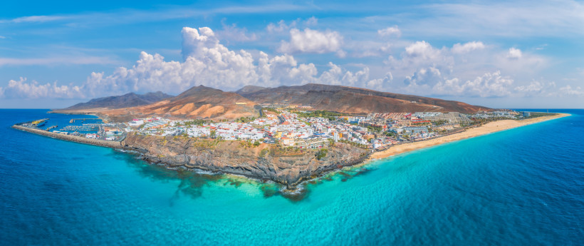 All-Inclusive-Hotels auf Fuerteventura – Panoramablick auf Jandía und das türkisblaue Meer Panoramaaufnahme von Jandía auf Fuerteventura mit Küste, Hotels und tiefblauem Atlantik