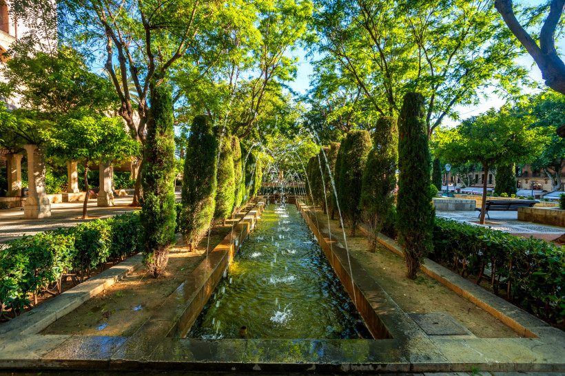 Schattiger Garten mit Wasserlauf nahe der Altstadt von Palma, ruhiger Stadtpark