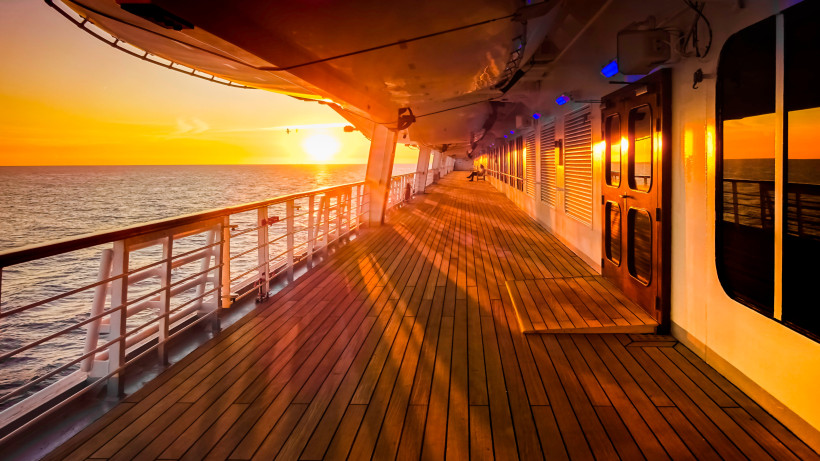 Sonnenuntergang über dem Atlantik vom Deck eines Schiffes mit Blick entlang der Reling