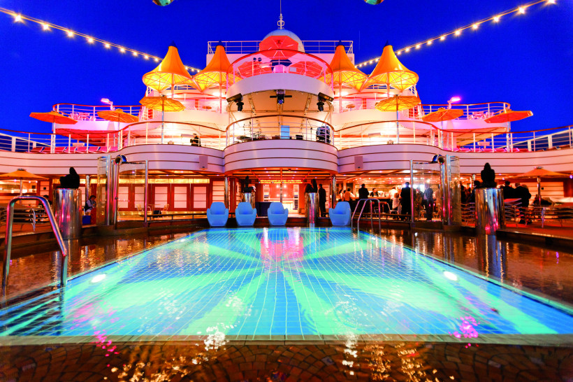 Costa Favolosa: beleuchtetes Pooldeck bei Nacht Pooldeck der Costa Favolosa bei Nacht mit beleuchtetem Swimmingpool und Passagierbereichen