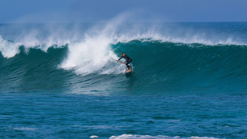Surfer auf einer großen Atlantikwelle vor Lanzarote, ideales Revier für Wassersport und Surfurlaub auf den Kanaren