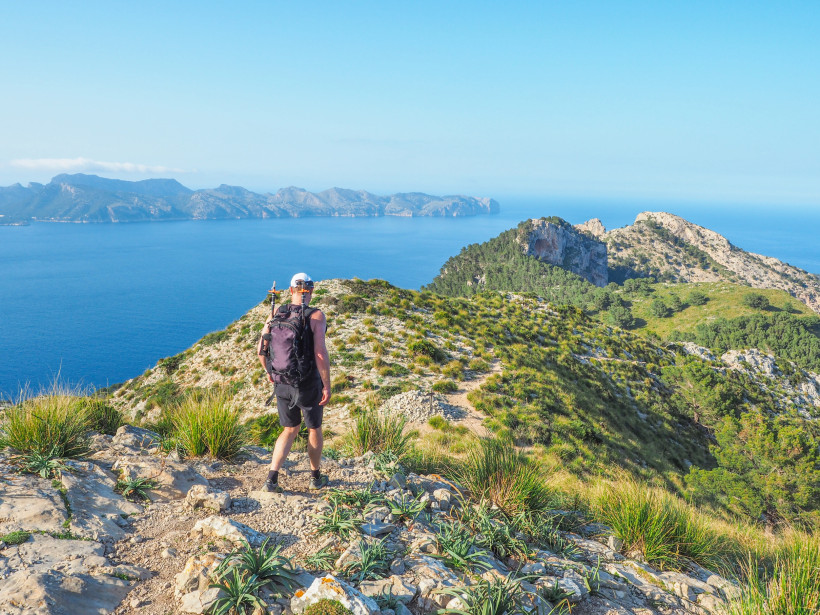 Wanderer auf einem Höhenweg bei Alcudia mit Blick auf die Steilküste und das offene Mittelmeer – beliebte Route für Aktivurlauber zwischen Natur und Erholung.
