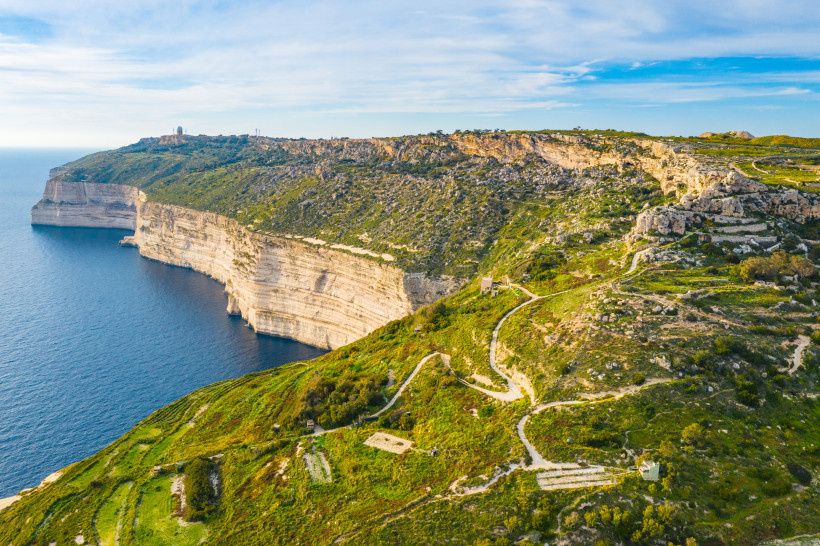 Dingli Cliffs Malta – Luftaufnahme der höchsten Klippen der Insel Luftaufnahme der Dingli Cliffs auf Malta mit Wanderwegen, grüner Landschaft und Blick auf das tiefblaue Meer