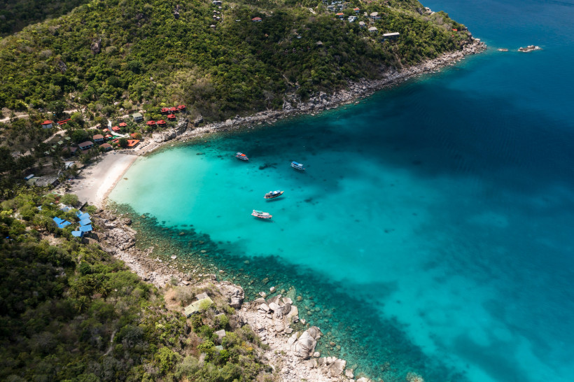 Ao Leuk Bay Koh Tao – Schnorchelparadies mit kristallklarem Wasser Ao Leuk Bay auf Koh Tao mit ruhigem, klarem Wasser, Felsformationen und grüner Vegetation – ideal zum Schnorcheln und Entspannen.