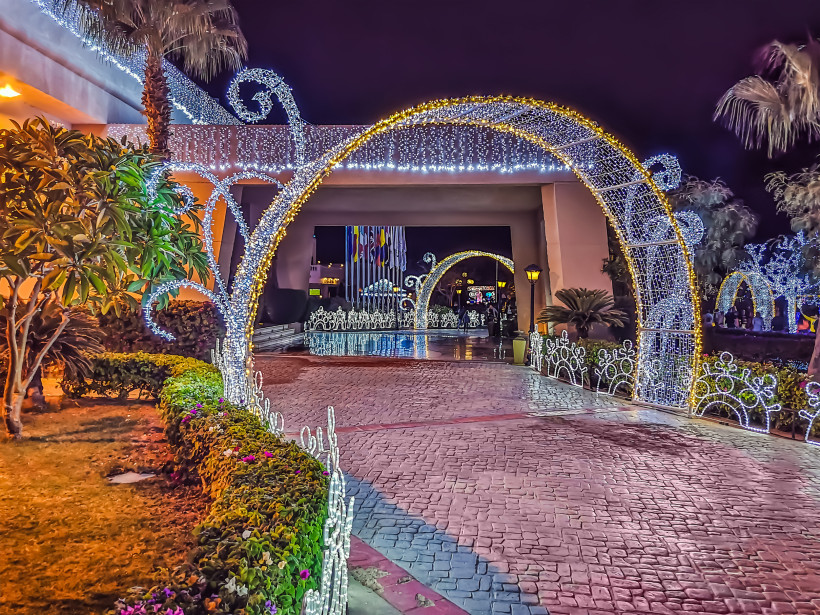 Nacht Soho Square mit Weihnachtsbeleuchtung in Sharm El Sheikh, Ägypten. Stadtbild mit gewölbtem, leuchtendem Tunnel im Freien