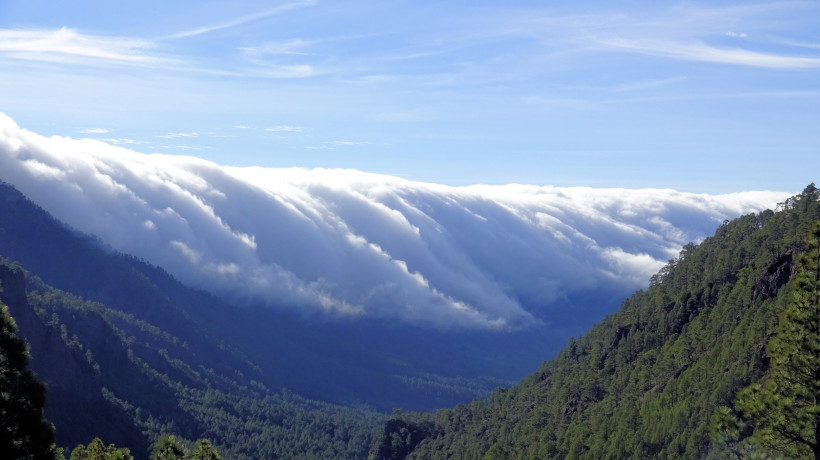Wolkenwasserfall Cascada de nubes über einem Bergtal Wolkenwasserfall (Cascada de nubes) über einem bewaldeten Bergtal